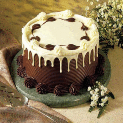 Heart-shaped chocolate cake with melting hearts design for couples