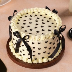Vanilla Charm Celebration Cake with ribbon design and creamy layers