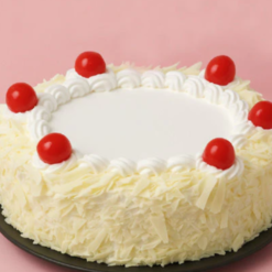 ivory cherry bliss cake with white cream layers and cherry topping